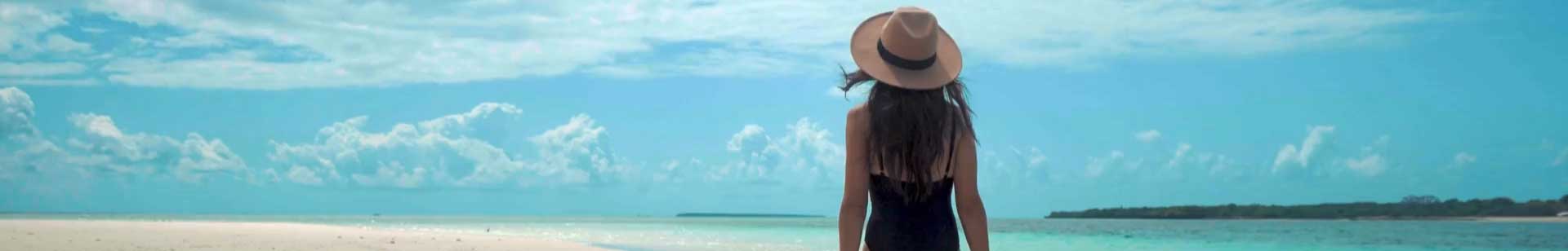 sized down height intro video with a woman on vacation walking on a beach